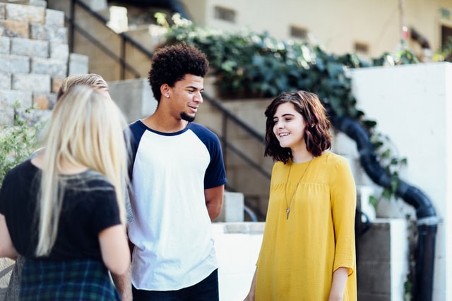 three friends walking in street and talking